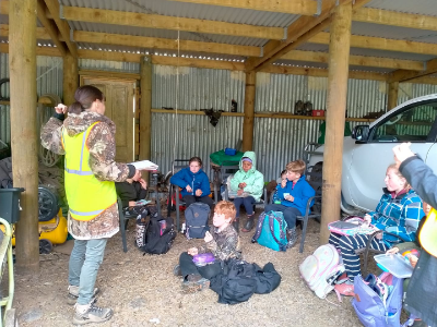 Pohatu penguin team member explaining protocols to the students